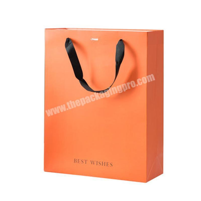 China wholesale paper bag custom simple paper bag high quality package orange gift paper bag with ribbon handle