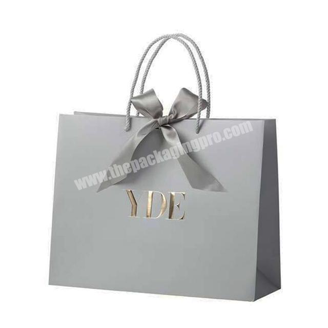 bowknot ribbon silver paper luxury bag with silk ribbon long handle embossed gold logo