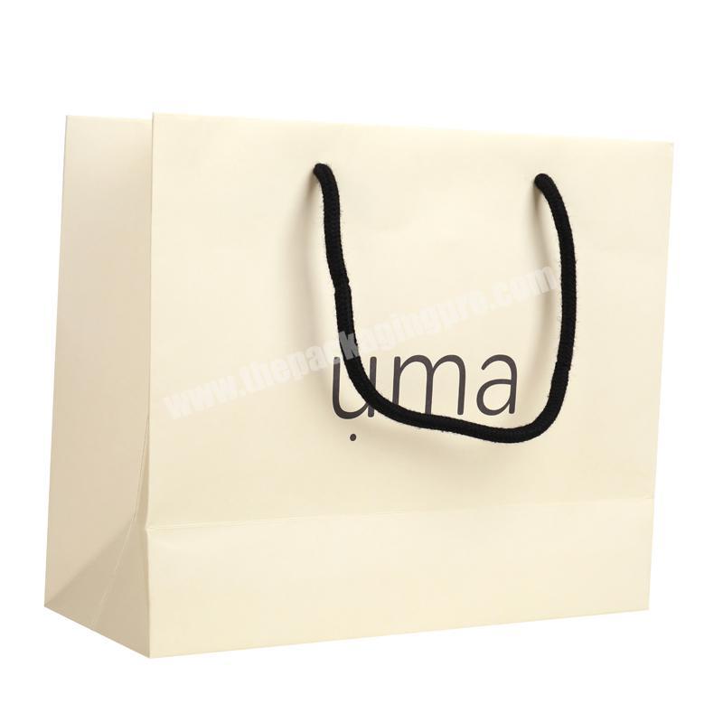Simple style beige 250g lamination ivory paper packaging bag popular for garments 2019