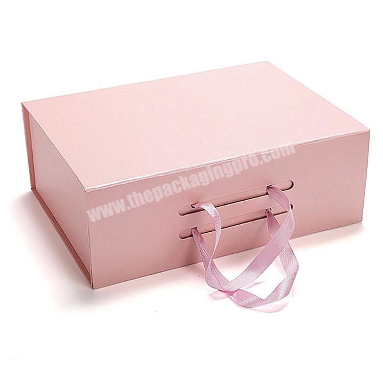 Pink cardboard folding magnetic handbag gift box for clothing with ribbon handle