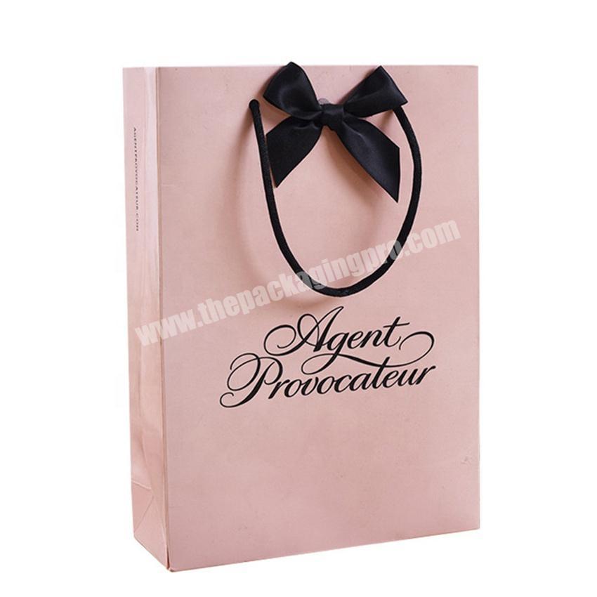 Beautiful Pink Paper Gift Bags with Butterfly Knot Decor.