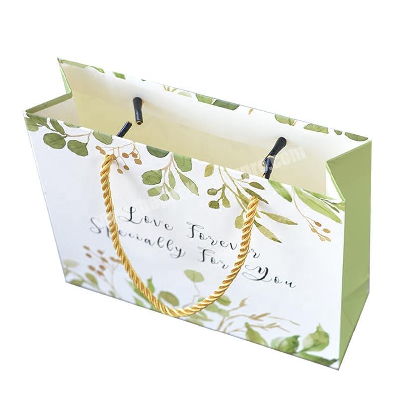 Custom Luxury Logo Printed Leaves Shopping Paper Gift Bag With Rope Handles For Clothing Packaging