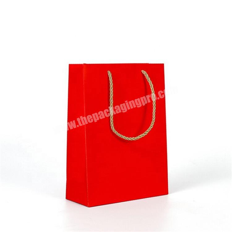Decorative red printed wedding gift bag with twisted handle