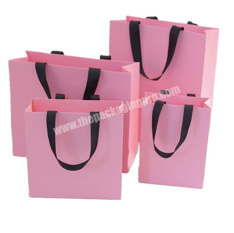Luxury pink fancy cardboard paper shopping bag with ribbon handle