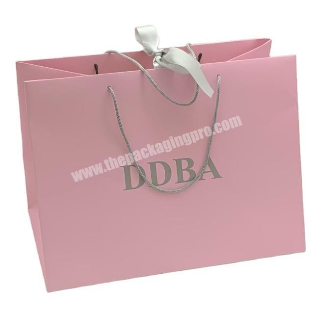 Wholesale fancy paper custom kraft paper pink shopping bag with handle ribbon