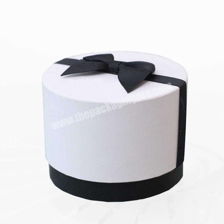white top and black bottom ribbon bowed all occasion round white gift boxes