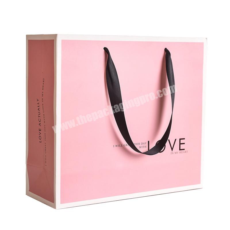 Pink color printed decorative handmade paper gift bags with handles