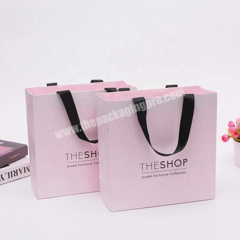 China wholesale paper bag pink clothes paper bag custom simple paper bag  with ribbon handle