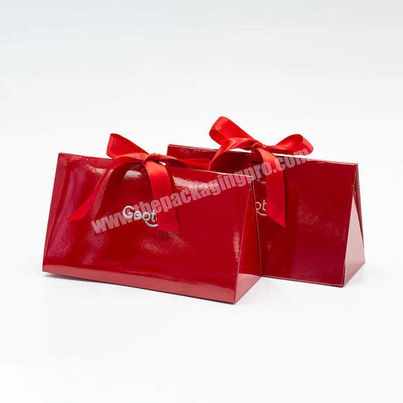 Custom brand logo printing creative red foldable triangle rigid cosmetic gift packaging box with ribbon bow