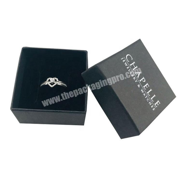 Cardboard small black paper ring box with foam inlay and white logo