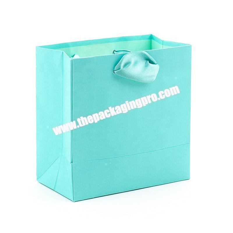 China Custom Black Logo Print Luxury Embossed Gift Paper Bag With Ribbon Handle
