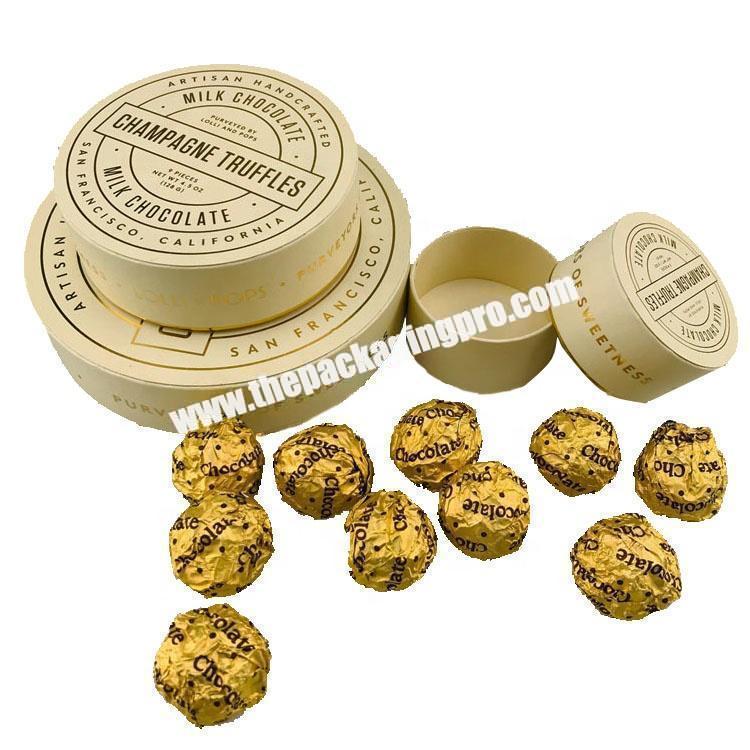 Box Of Round Candies Wrapped Into Golden Foil. One Chocolate Is