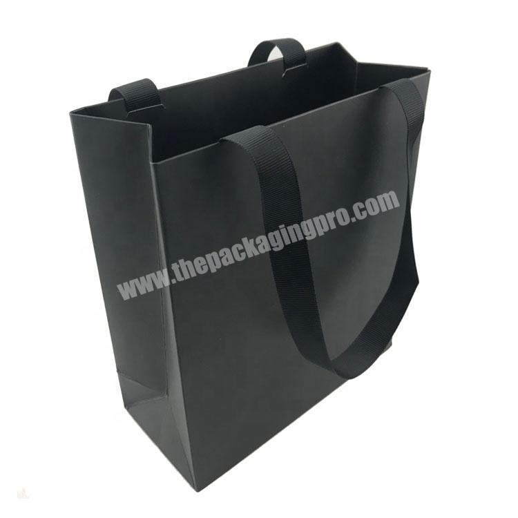 Elegant matte black paper shopping bag with black ribbon handle