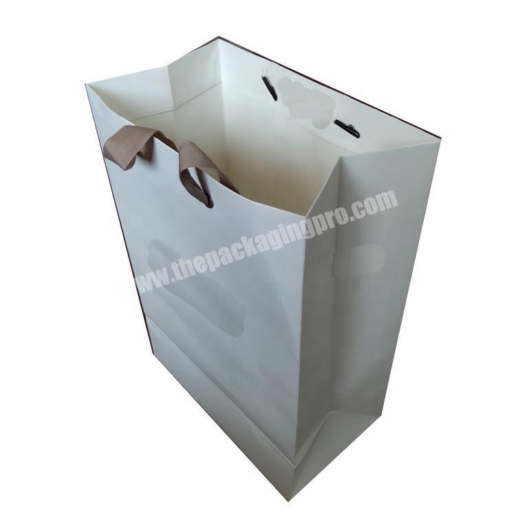 Fancy white paper shopping bag for clothing and shoe packaging