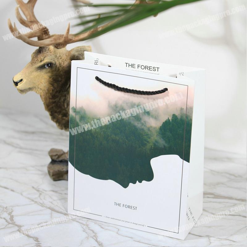 High quality low price high grade forest image custom picture printed packaging white paper gift bag