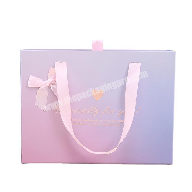 High quality wholesale custom cheap paper packaging box for simple packaging with handles for clothing gifts