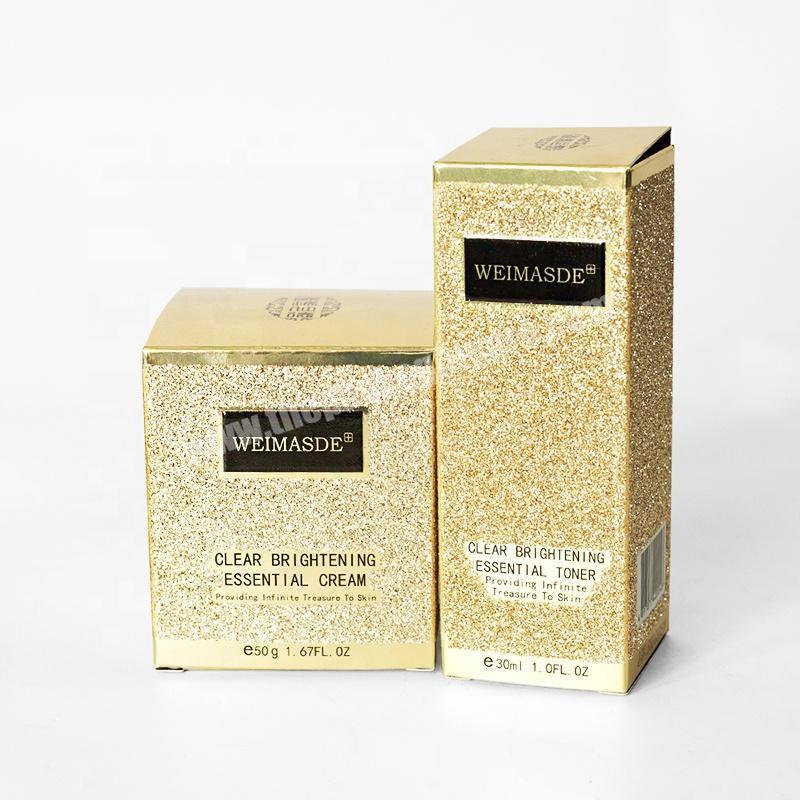 Luxury gold cosmetic bottles packaging cardboard box with shining powder