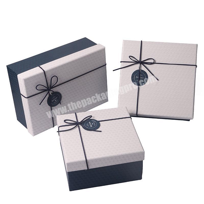 Paper gift packaging lid and base box with ribbon