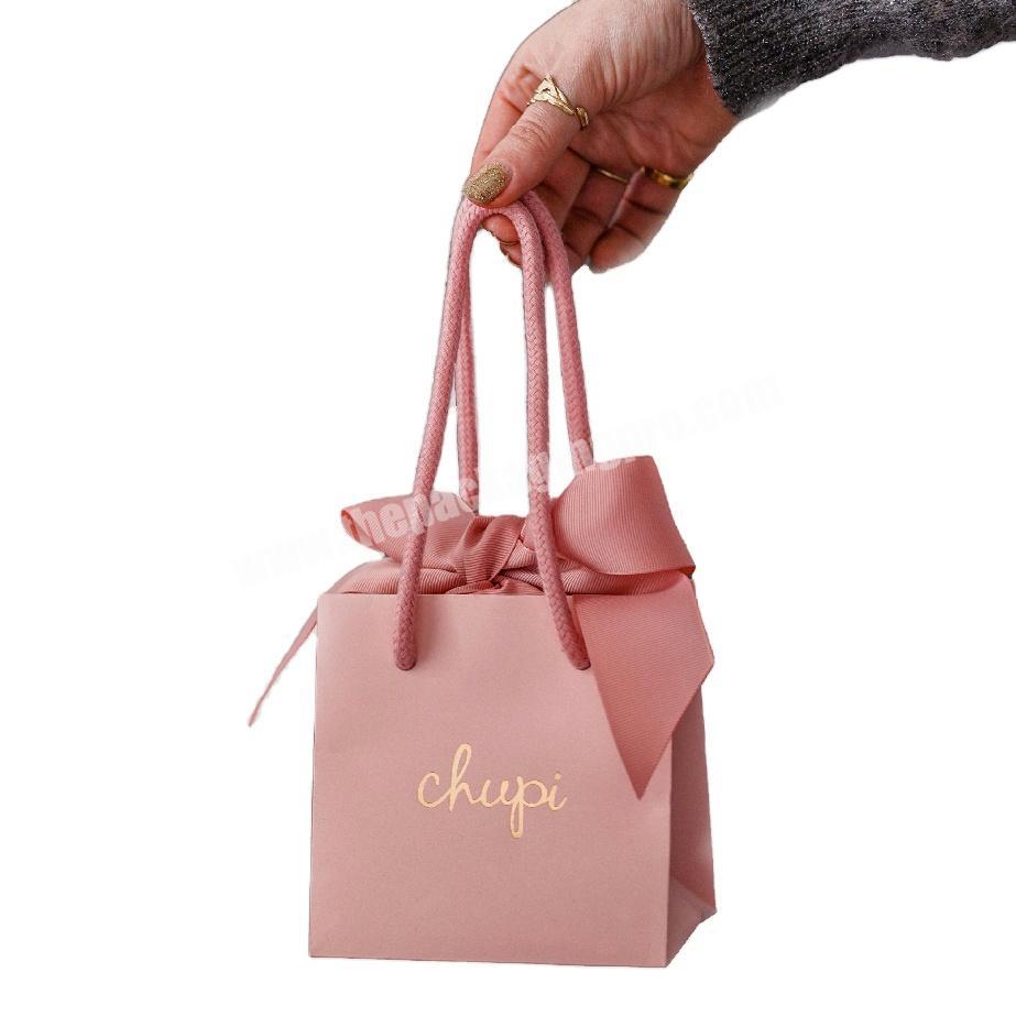 small pink paper gift bags with nice ribbon closure