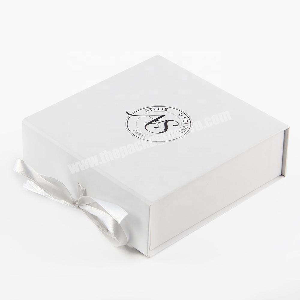 White cosmetic product package paper cardboard box with ribbon