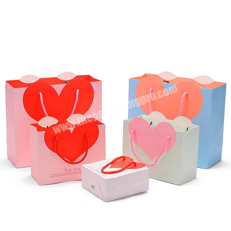 Wholesale loop handle heart shape cosmetics promotion gift paper bags