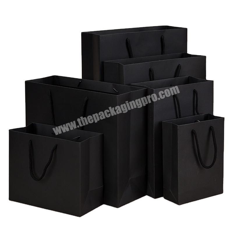 Yiwu factory custom kraft paper handbag black art paper holographic hot stamping clothing gift bag