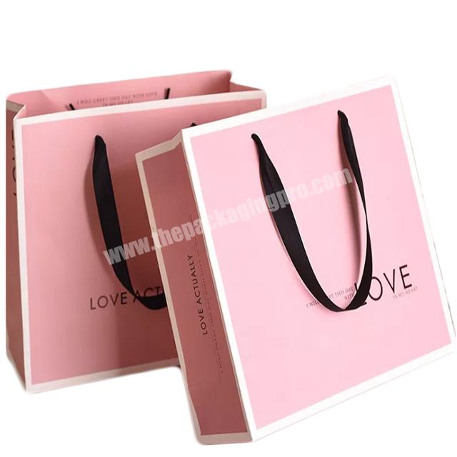 Customized luxury pink paper cardboard bags shopping clothes folding retail paper gift bag with your own logo
