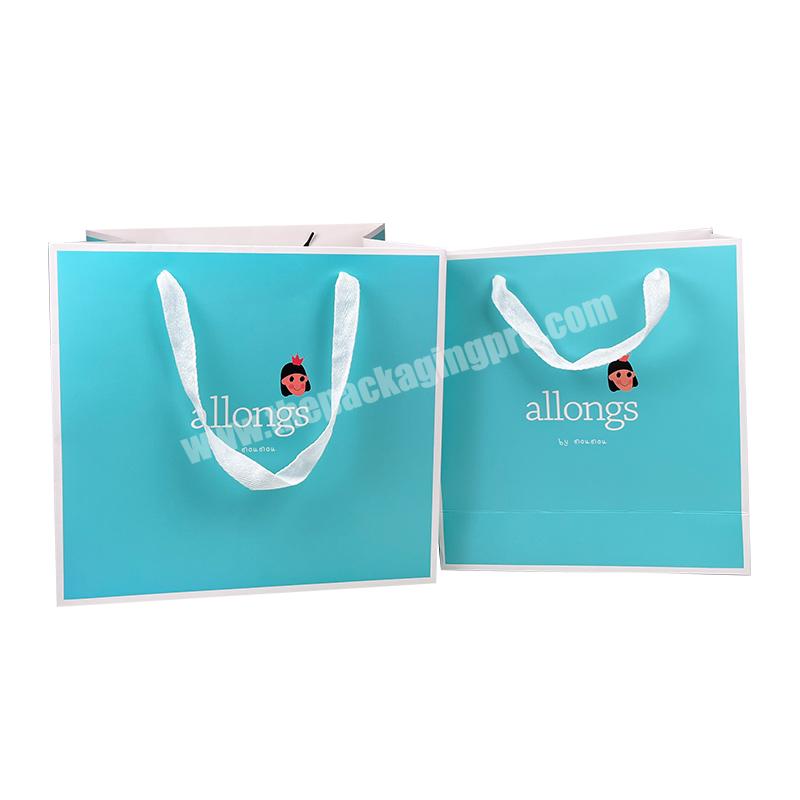 Hot sale  Luxury Blue Color Custom Your Own Logo White Card Paper Bag For Gift Packaging With Ribbon Handle