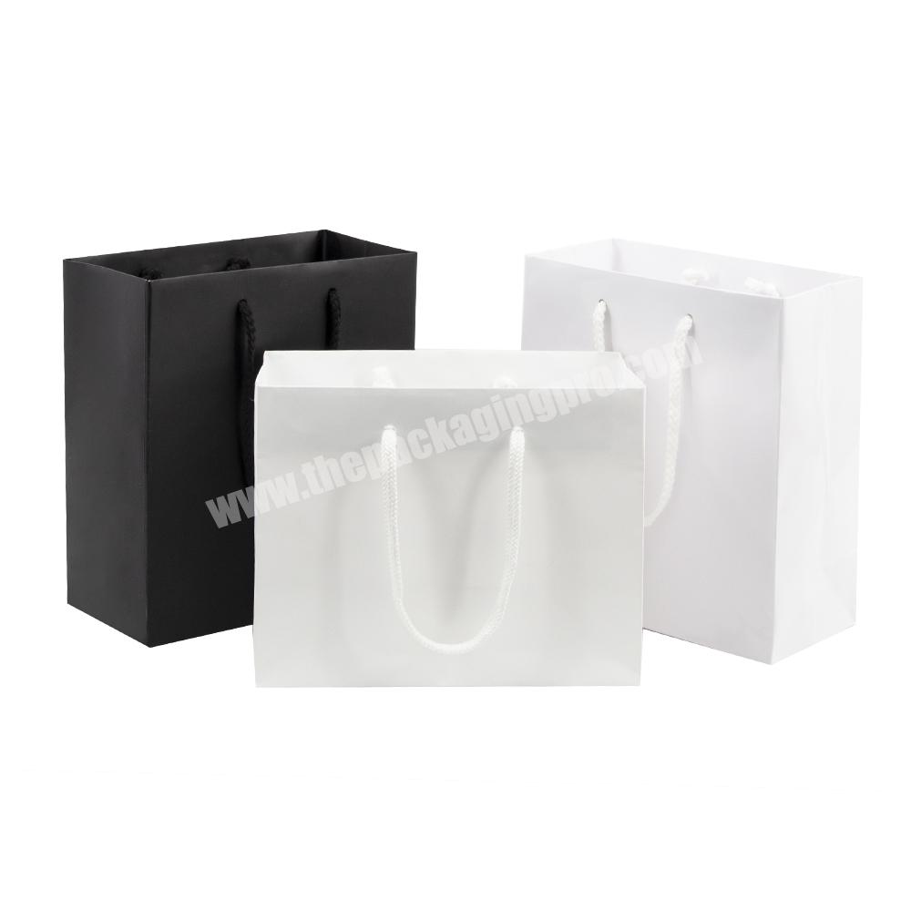 Wholesale customised luxury clothing paper bag white color shopping gift packaging bag
