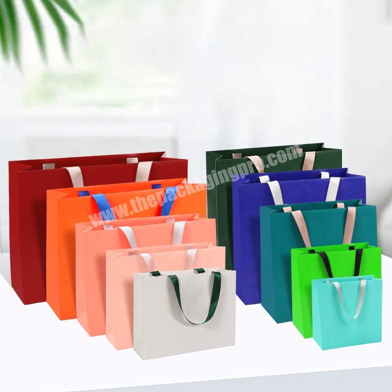 China Yiwu Ready To Ship Orange Blue Green Custom Logo Printed Luxury Gift Paper Bags with ribbon handle